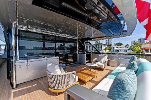 Slide: The Image of Luxurious 2024 Riva 102 Corsaro Super yacht deck with modern seating and waterfront view. - 31