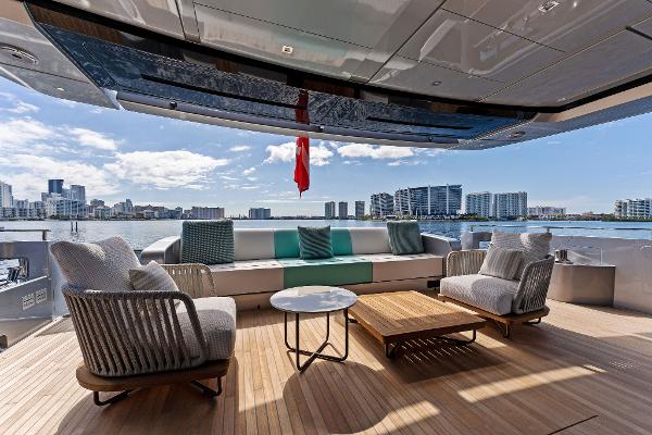Slide: The Image of Luxurious 2024 Riva 102 Corsaro Super yacht deck with modern seating and waterfront view. - 34