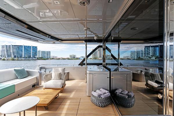 Slide: The Image of Luxurious 2024 Riva 102 Corsaro Super yacht deck with modern seating and scenic waterfront view. - 36