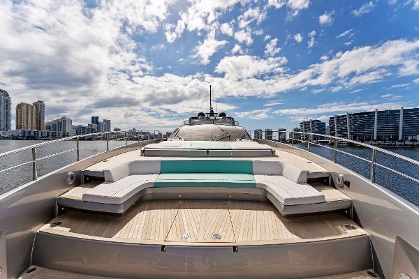 Slide: The Image of 2024 Riva 102 Corsaro Super yacht with luxurious deck and city skyline backdrop. - 38