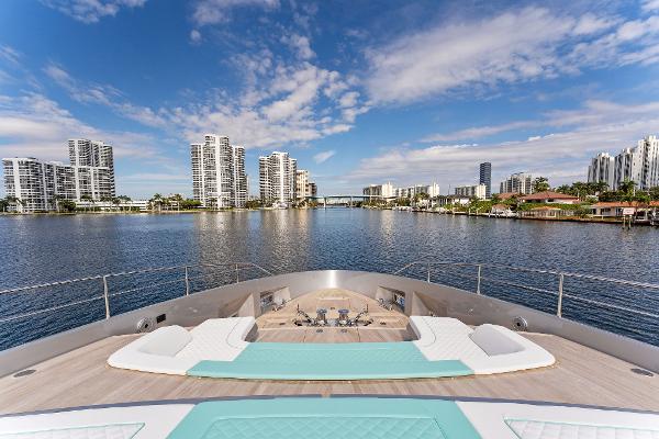 Slide: The Image of Luxurious 2024 Riva 102 Corsaro Super yacht with city skyline and waterfront view. - 39
