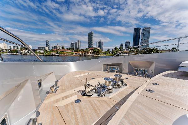 Slide: The Image of Luxurious 2024 Riva 102 Corsaro Super yacht deck with city skyline backdrop. - 41