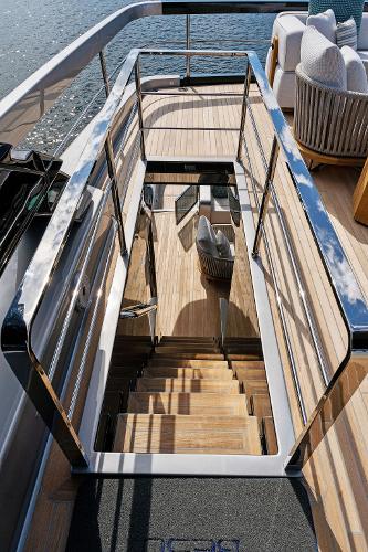 Slide: The Image of Luxurious 2024 Riva 102 Corsaro Super yacht staircase with sleek wooden design and modern railings. - 42