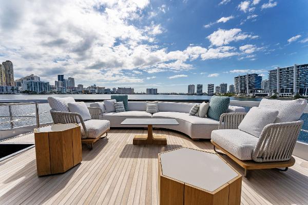 Slide: The Image of Luxurious deck of 2024 Riva 102 Corsaro Super yacht with modern seating and city skyline view. - 43