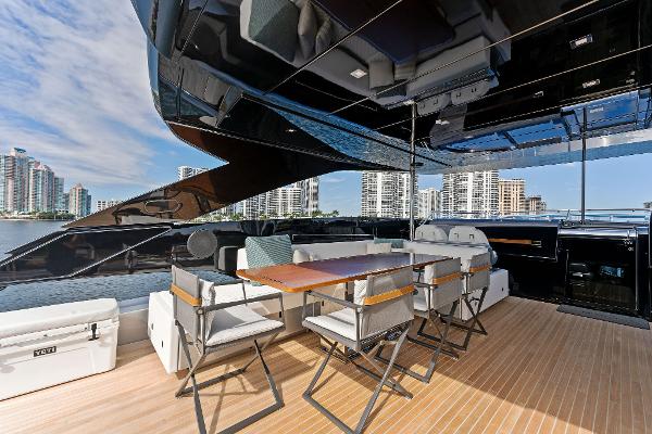 Slide: The Image of Luxurious 2024 Riva 102 Corsaro Super yacht deck with modern seating and cityscape view. - 45