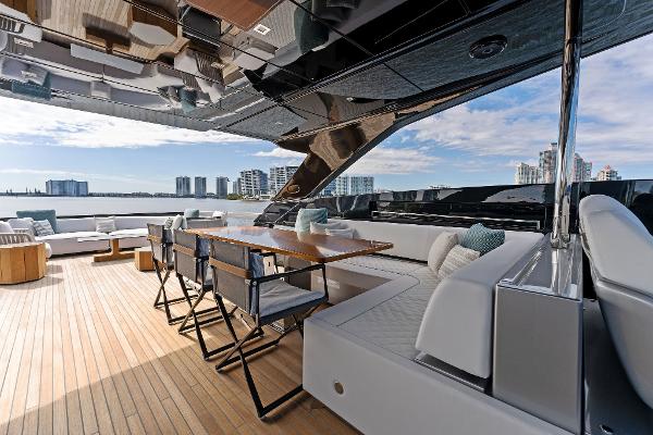 Slide: The Image of Luxurious deck of 2024 Riva 102 Corsaro Super yacht with modern seating and city skyline view. - 47