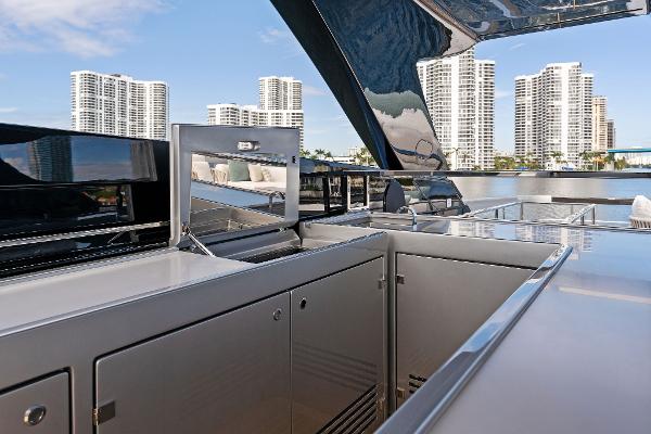 Slide: The Image of Luxurious 2024 Riva 102 Corsaro Super yacht deck with modern amenities and city skyline view. - 49
