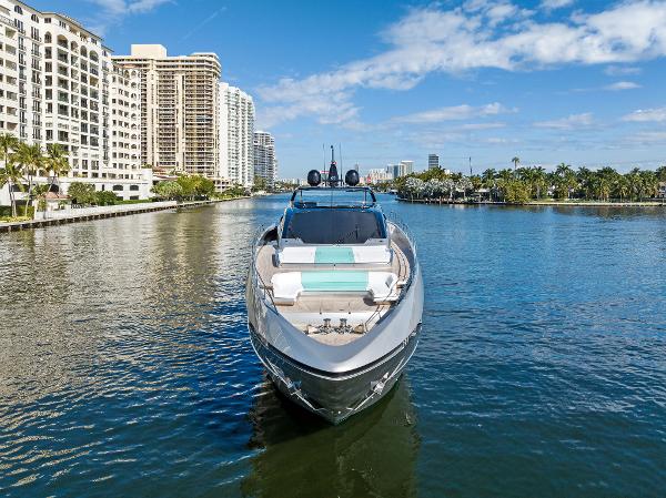 Slide: The Image of 2024 Riva 102 Corsaro Super yacht cruising in a scenic urban waterway. - 6
