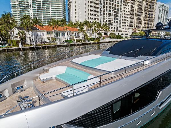 Slide: The Image of Luxurious 2024 Riva 102 Corsaro Super yacht docked near waterfront cityscape. - 7