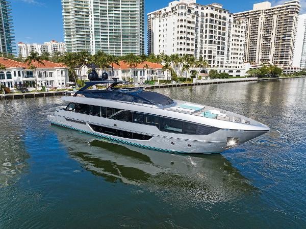 Slide: The Image of 2024 Riva 102 Corsaro Super yacht cruising near waterfront buildings. - 9