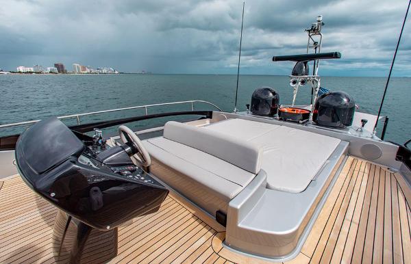 Slide: The Image of Riva 88 Domino Super 2017 yacht deck with seating and helm, overlooking the ocean. - 17
