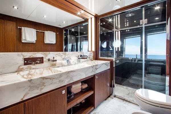 Slide: The Image of Luxurious bathroom on a 2017 Riva 88 Domino Super yacht with marble sink and ocean view. - 37