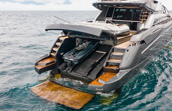 Slide: The Image of 2017 Riva 88 Domino Super yacht with jet ski garage open on the water. - 7