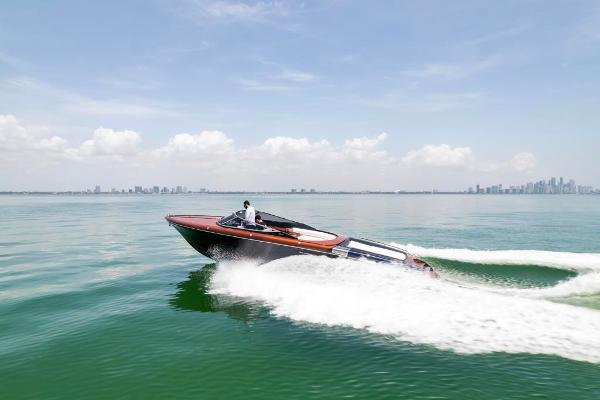 Slide: The Image of 2020 Riva Aquariva Super speedboat cruising on calm waters with city skyline in the background. - 1