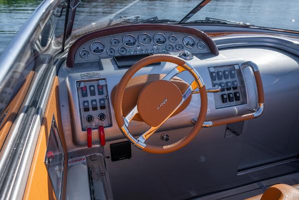 Slide: The Image of 2020 Riva Aquariva Super boat dashboard with steering wheel and control panel. - 18