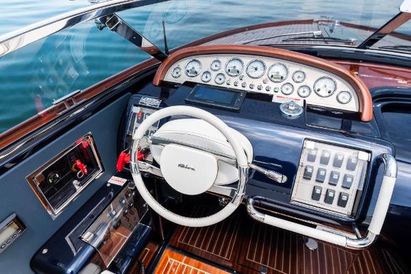 Slide: The Image of Cockpit of 2020 Riva Aquariva Super luxury yacht with modern controls and wooden accents. - 18