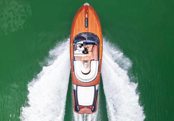 Slide: The Image of Top view of 2020 Riva Aquariva Super luxury yacht cruising on green water. - 2