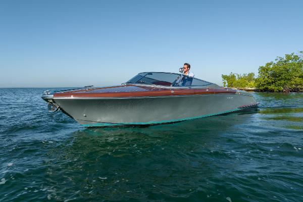 Slide: The Image of 2020 Riva Aquariva Super luxury boat cruising on clear blue water. - 6
