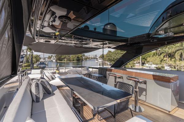 Slide: The Image of Luxurious 2019 Riva ARGO yacht deck with seating, table, and bar area. - 21