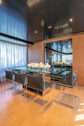 Slide: The Image of Modern dining area on 2019 Riva ARGO yacht with glass table and sleek chairs. - 5