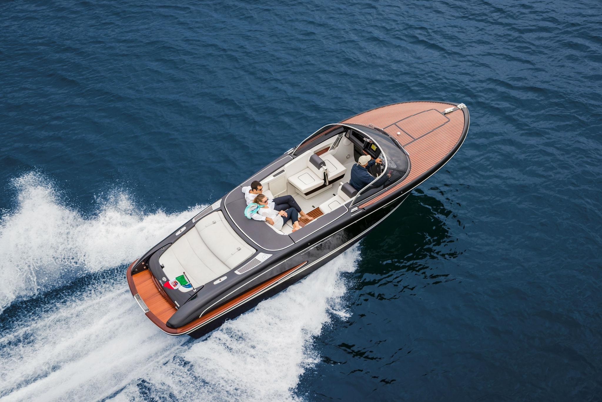 Slide: The Image of 2025 Riva Iseo luxury motorboat cruising on open water. - 0