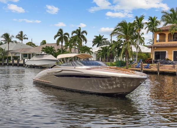 Slide: The Image of Luxurious 2010 Riva Rama boat cruising in a tropical waterfront setting. - 0