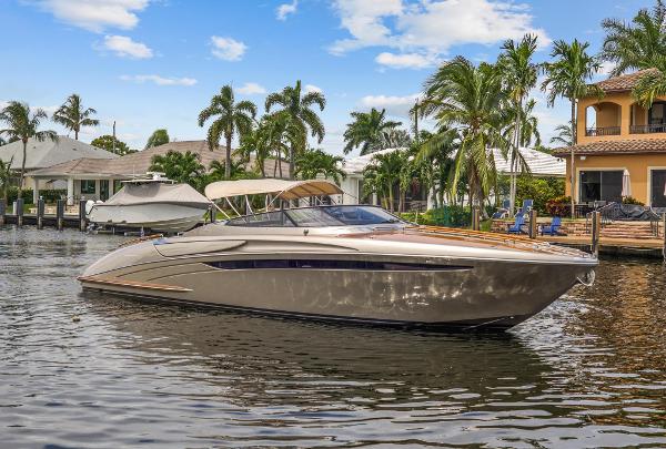 Slide: The Image of Luxury 2010 Riva Rama boat docked in a tropical waterfront setting. - 1
