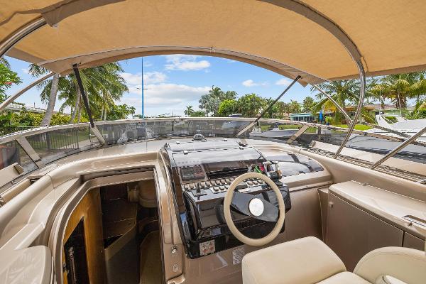Slide: The Image of 2010 Riva Rama yacht cockpit with steering wheel and control panel under canopy. - 11