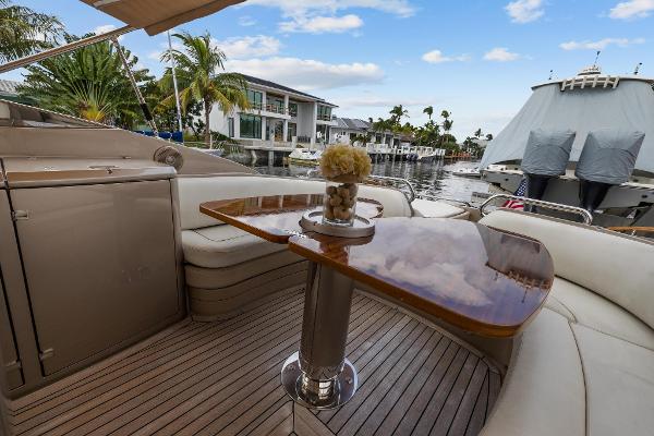 Slide: The Image of Luxury deck of 2010 Riva Rama yacht with wooden table and waterfront view. - 13