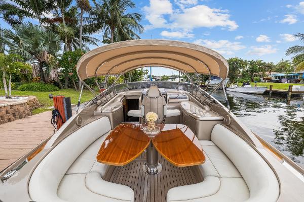 Slide: The Image of Luxury 2010 Riva Rama boat with elegant seating and wooden table docked by a scenic waterfront. - 14