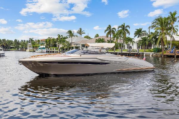 Slide: The Image of 2010 Riva Rama boat cruising on a sunny day in a tropical waterfront setting. - 4
