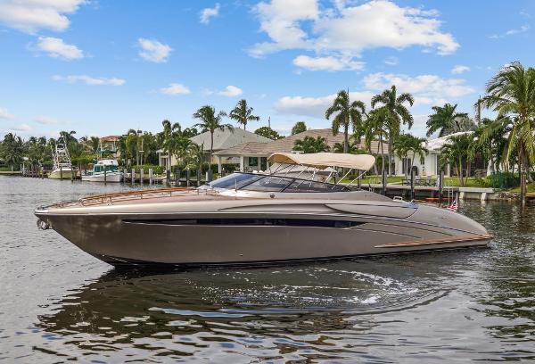 Slide: The Image of 2010 Riva Rama luxury yacht cruising on a sunny day near waterfront homes. - 5