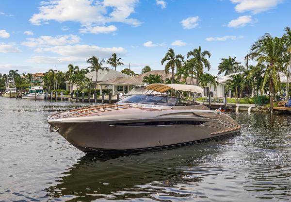 Slide: The Image of 2010 Riva Rama luxury yacht cruising in a tropical marina with palm trees and waterfront homes. - 7