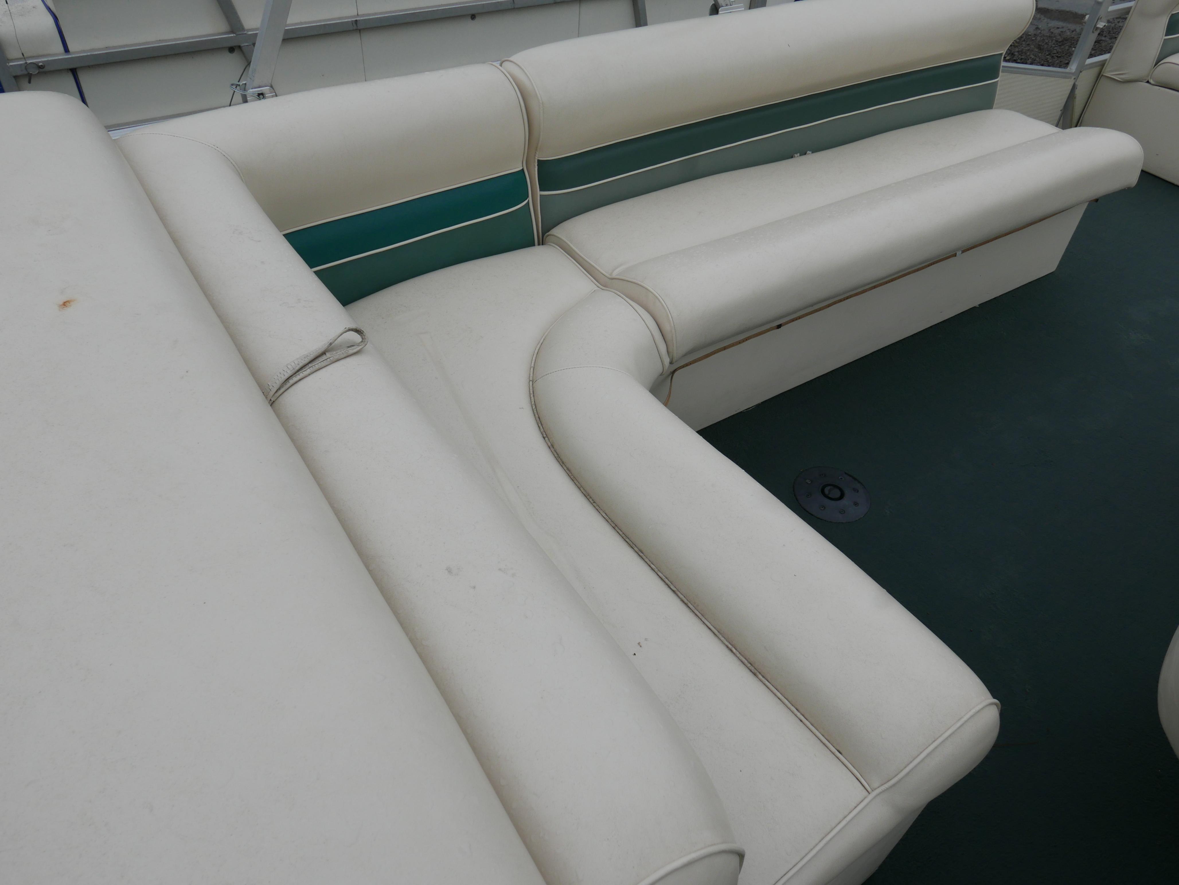 Slide: The Image of 2000 Riviera Cruiser Cruise boat interior with white and green cushioned seating. - 10