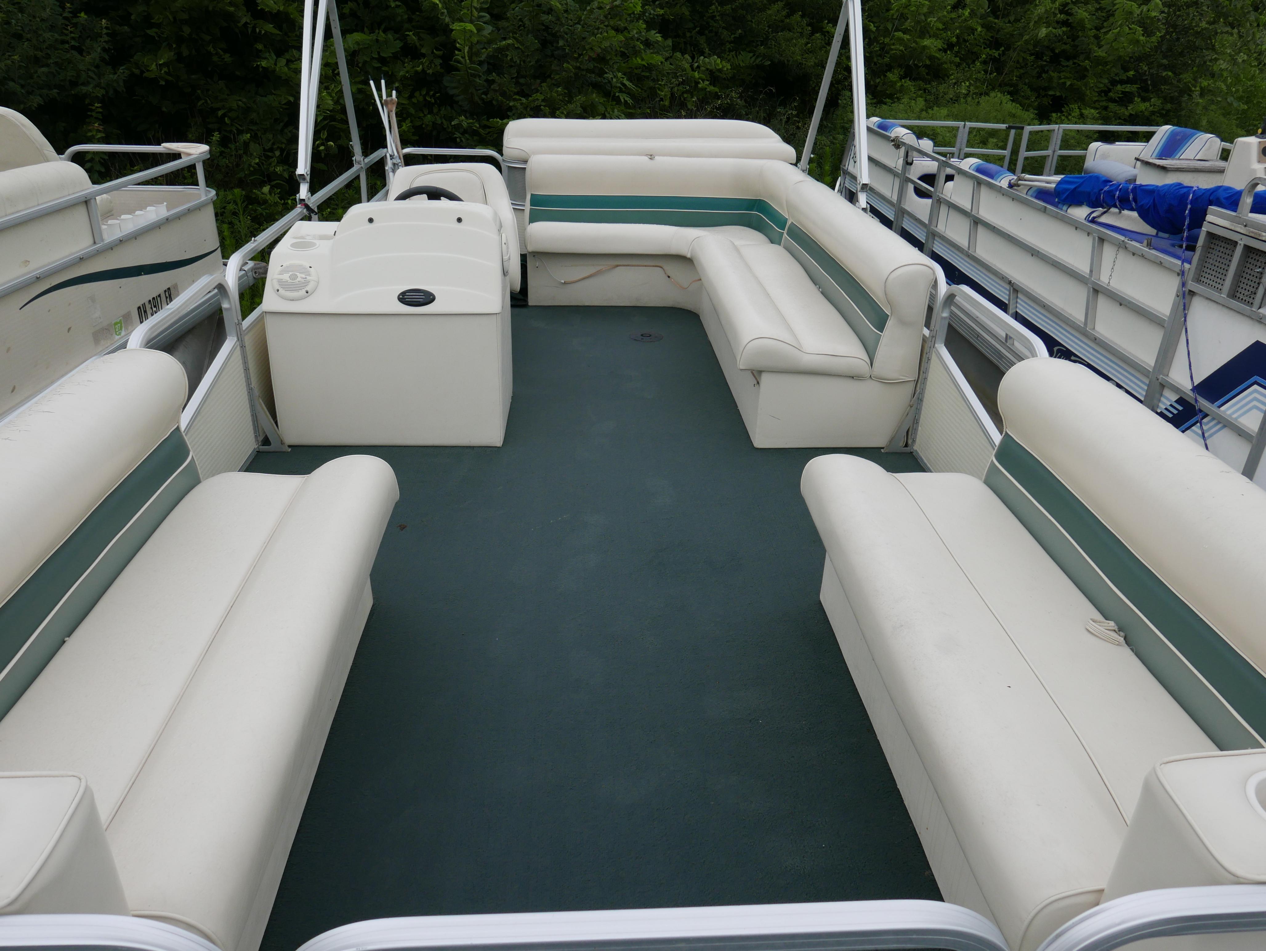 Slide: The Image of 2000 Riviera Cruiser pontoon boat with spacious seating and green carpet. - 3