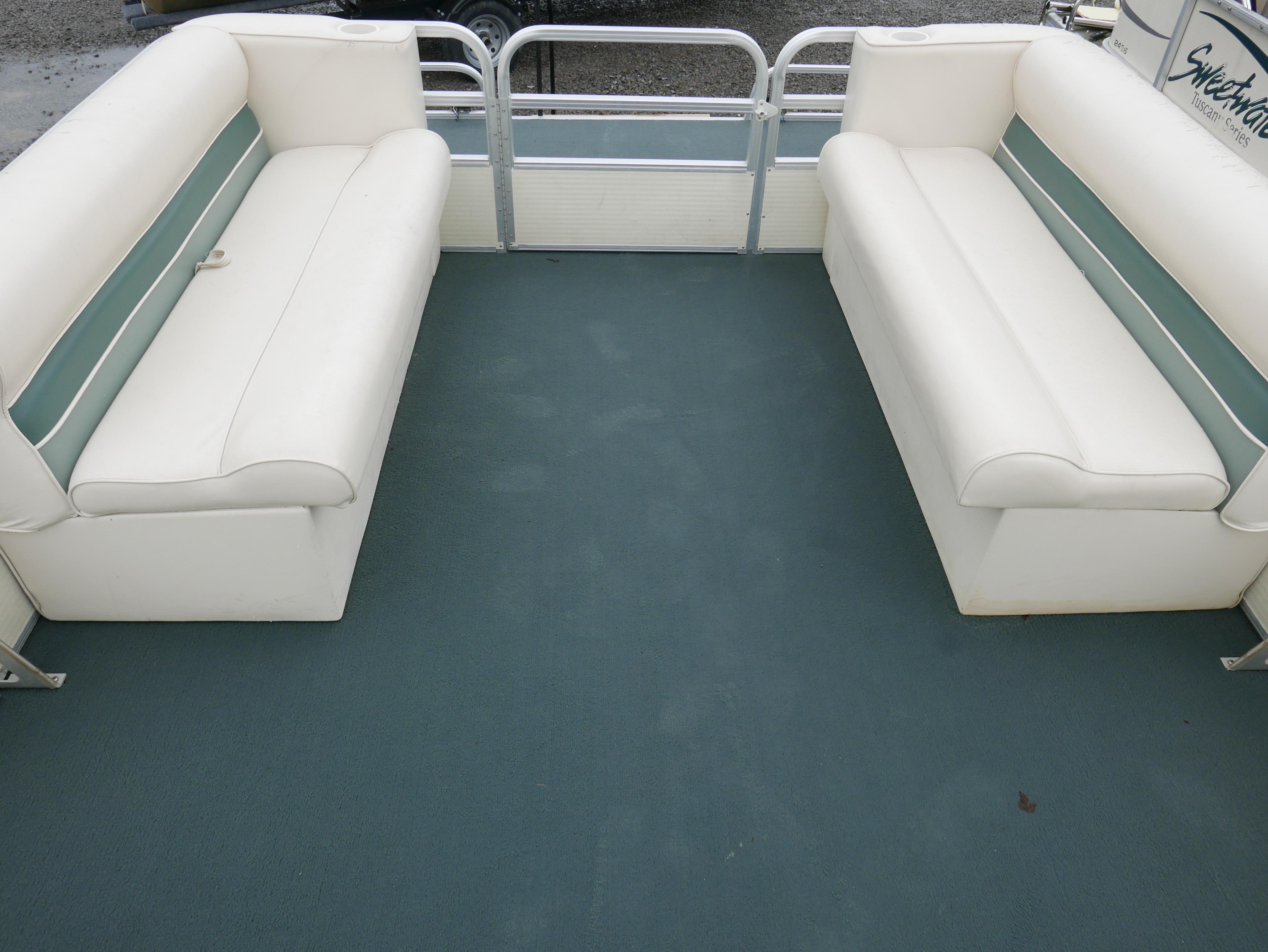 Slide: The Image of 2000 Riviera Cruiser Cruise boat interior with white seating and teal carpet. - 4