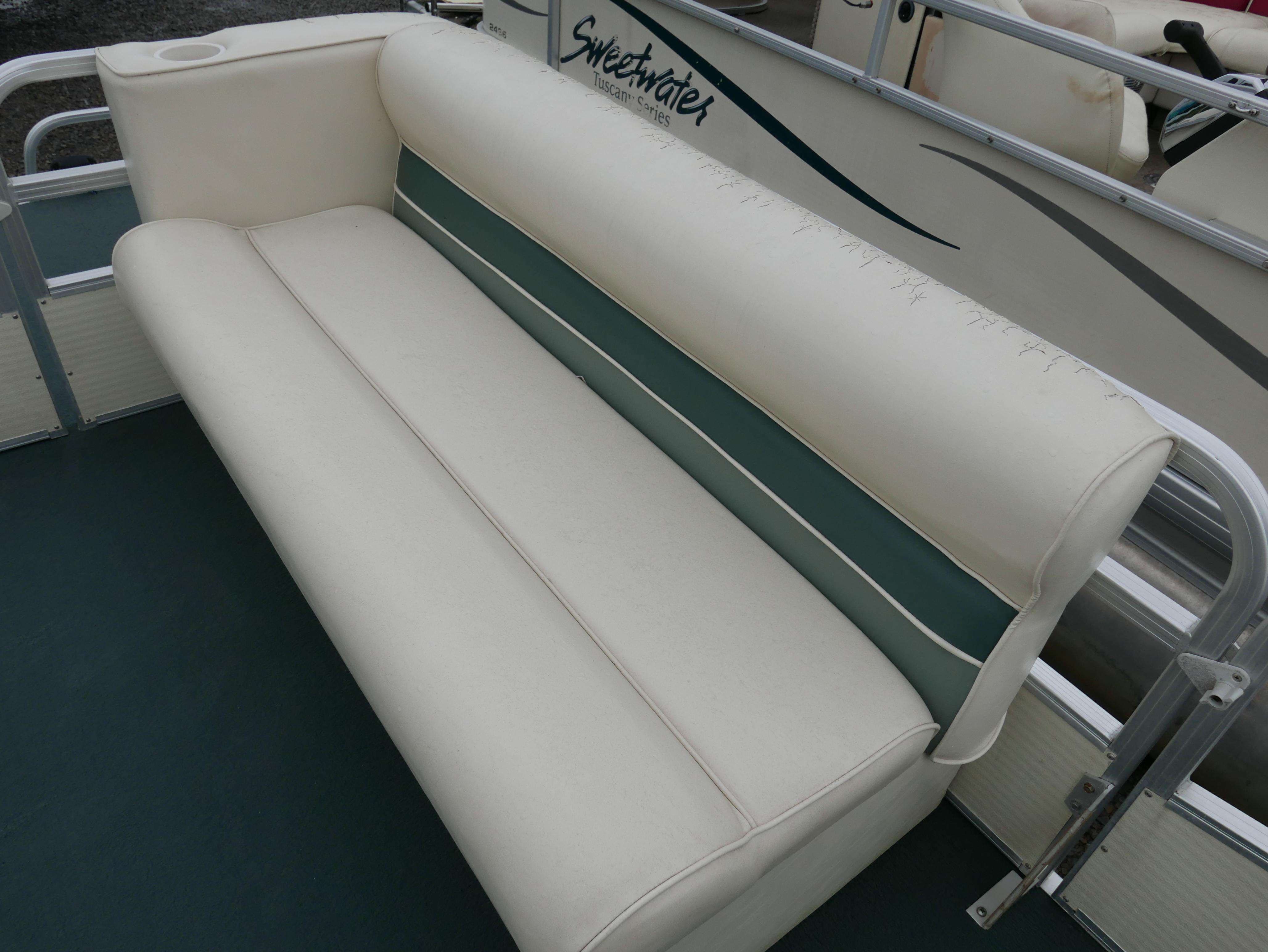 Slide: The Image of White and green seating on a 2000 Riviera Cruiser pontoon boat. - 6