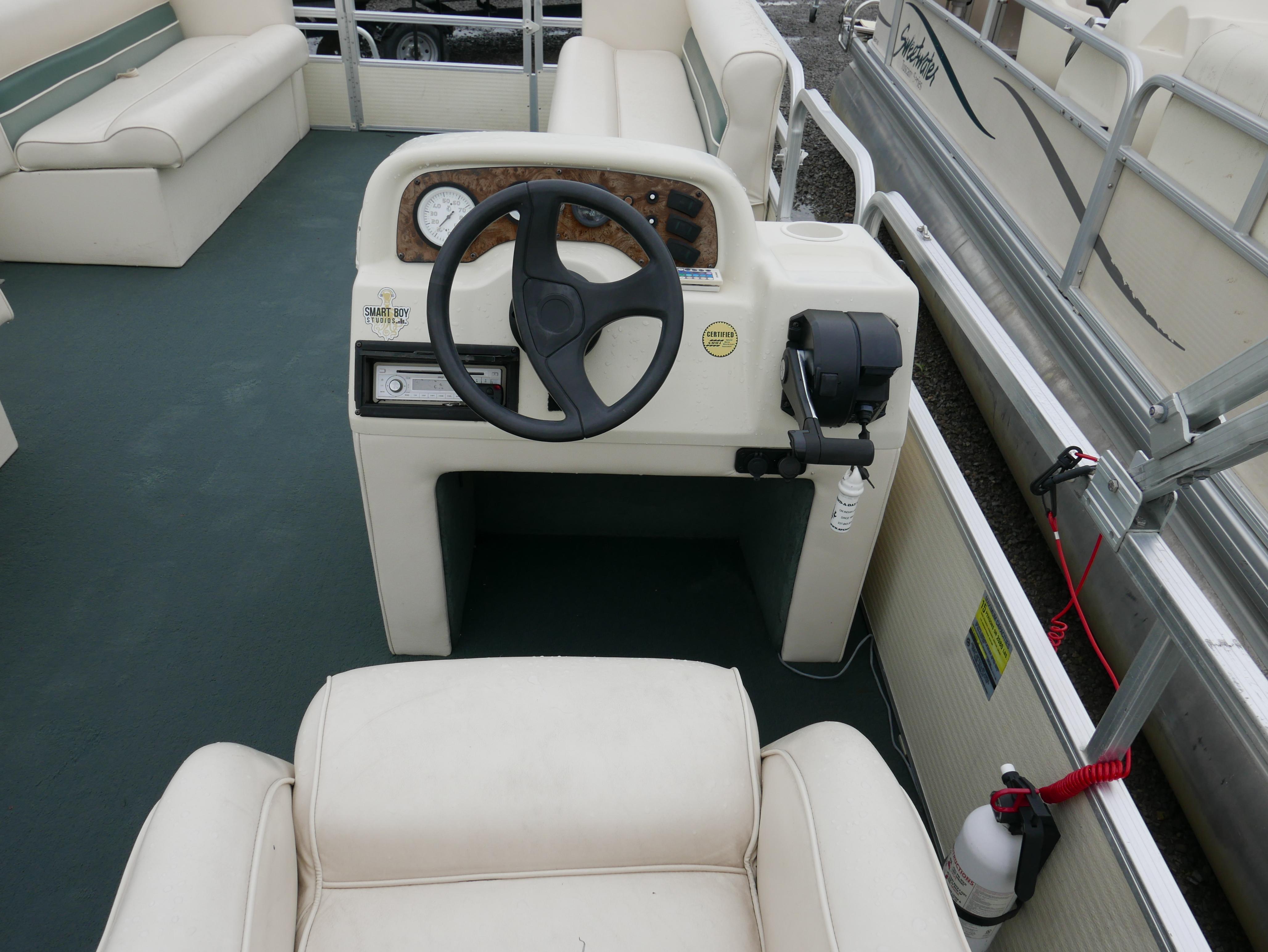 Slide: The Image of 2000 Riviera Cruiser Cruise boat interior with steering wheel and seating. - 8