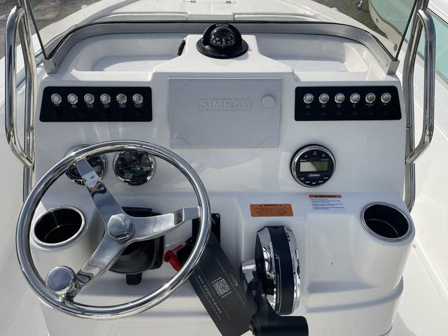 Slide: The Image of 2024 Robalo 206 Cayman boat console with steering wheel and controls. - 13