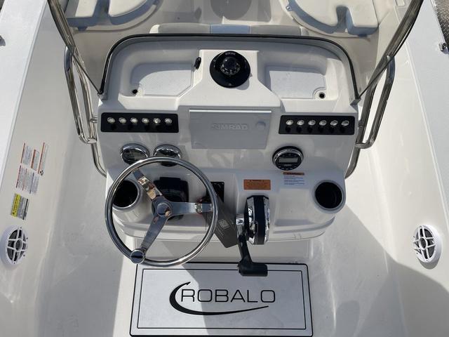 Slide: The Image of 2024 Robalo 206 Cayman boat console with steering wheel and controls. - 14