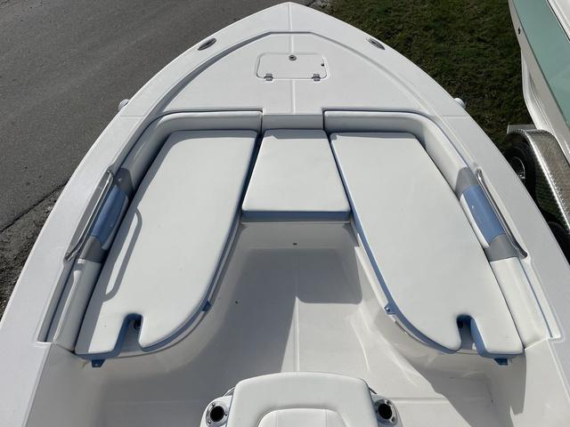 Slide: The Image of 2024 Robalo 206 Cayman boat bow seating area with white cushions. - 20