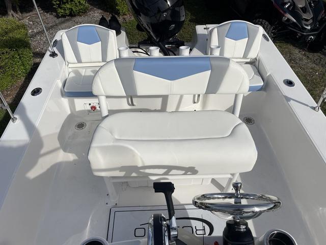 Slide: The Image of 2024 Robalo 206 Cayman boat interior with white seating and steering console. - 32