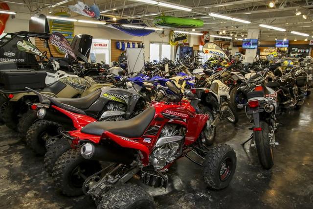 Slide: The Image of Showroom filled with various motorcycles, ATVs, and off-road vehicles. - 44