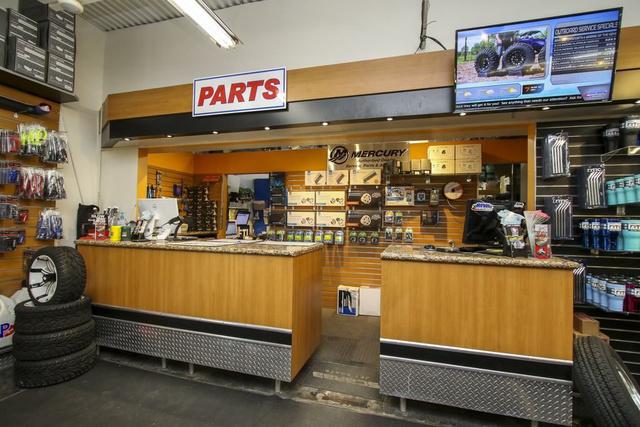 Slide: The Image of Boat parts store interior with service counter and display shelves, featuring Robalo 206 Cayman 2024 model. - 45