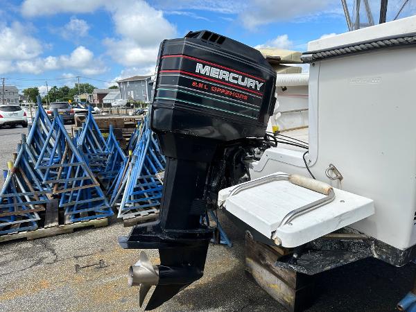 Slide: The Image of 1994 Robalo 2160 Cuddy Cabin with Mercury outboard motor in a boatyard. - 3