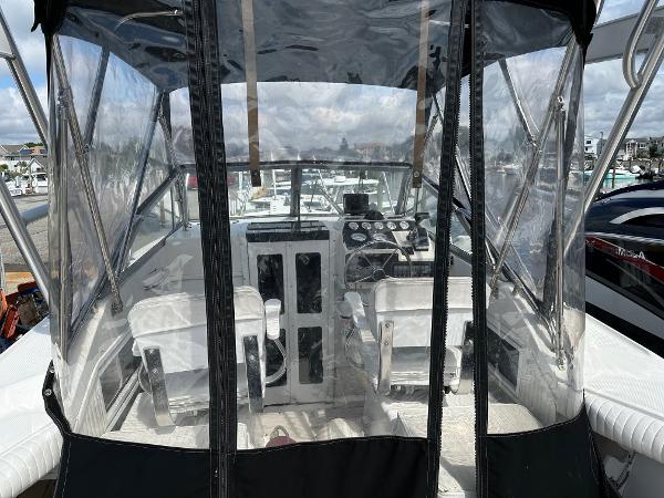Slide: The Image of 1994 Robalo 2160 Cuddy Cabin boat interior with clear enclosure and dual seats. - 6