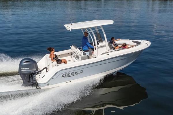 Slide: The Image of 2024 Robalo 222 Explorer boat cruising on water with passengers enjoying the ride. - 1