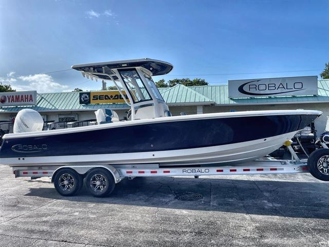 Slide: The Image of 2023 Robalo 266 Cayman boat on a trailer at a dealership. - 1