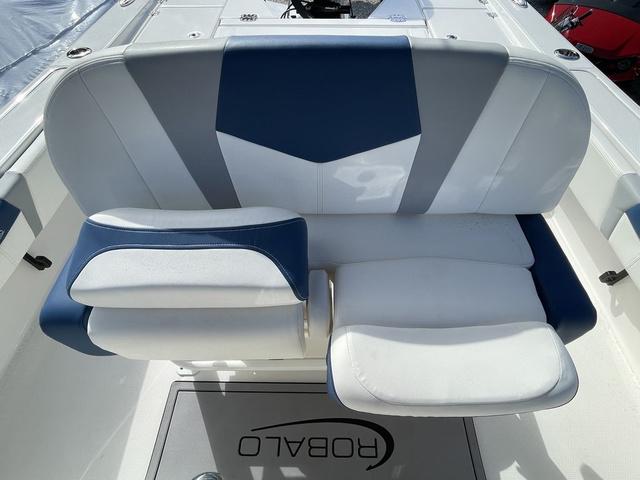 Slide: The Image of 2023 Robalo 266 Cayman boat seating area with blue and white upholstery. - 21