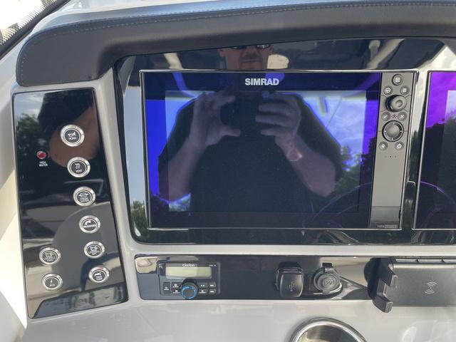 Slide: The Image of 2023 Robalo 266 Cayman dashboard with Simrad display and control buttons. - 7
